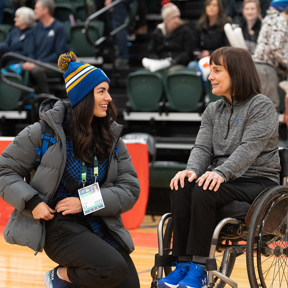A mental Performance Consultant chats with a wheelchair basketball coach