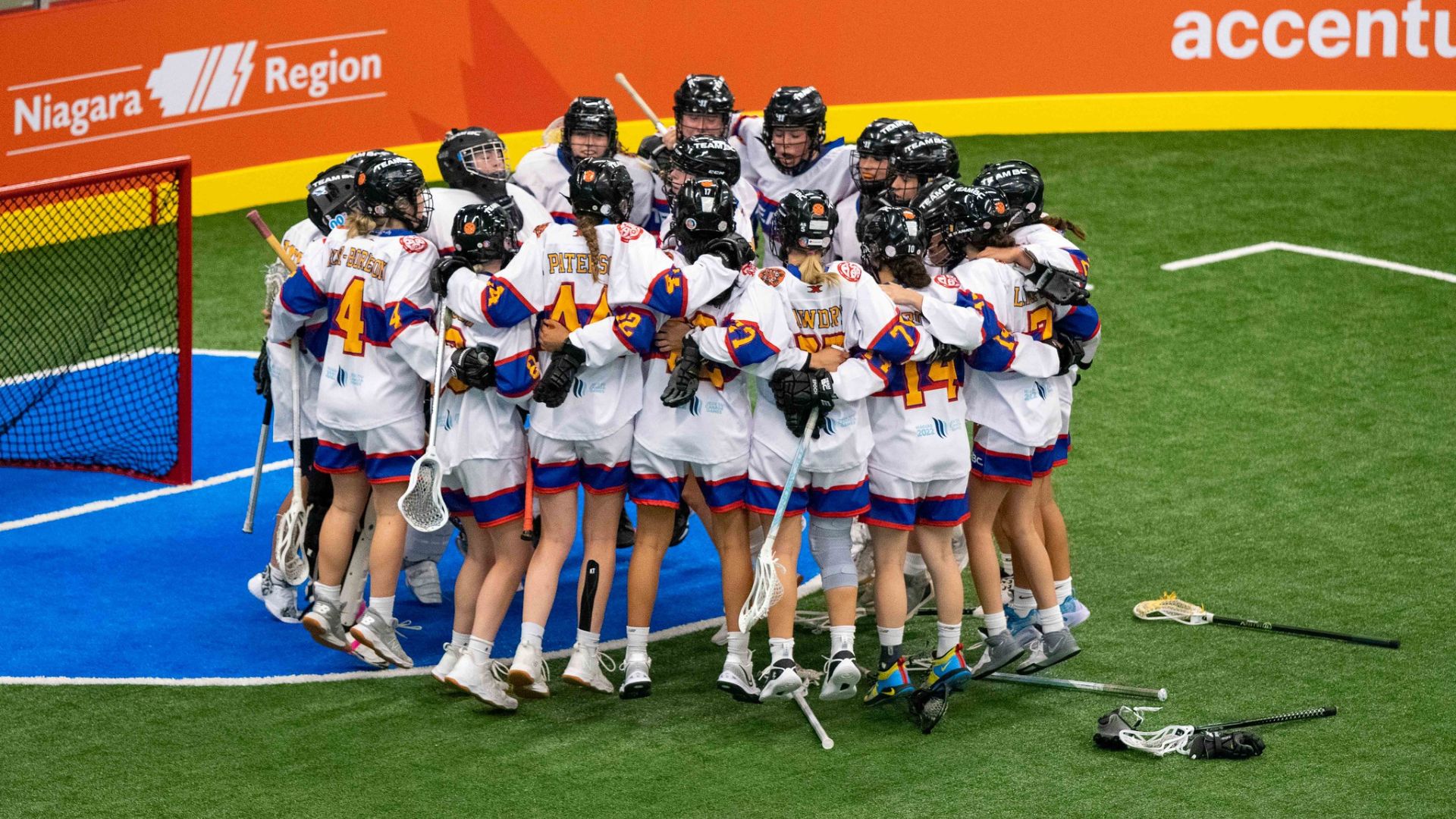 Team BC girls lacrosse team comes together in a huddle at the Canada Games.